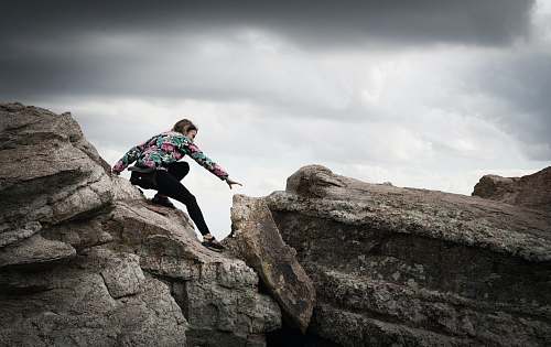 woman woman climbing on rocks during daytime photography coronado national forest